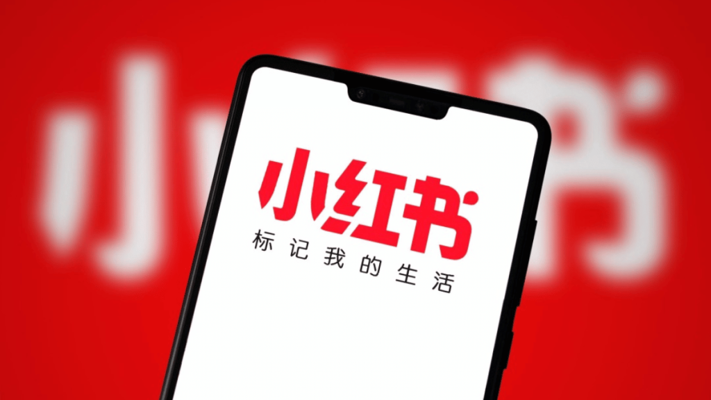 smartphone displaying the Xiao Hong Shu logo on a red background.