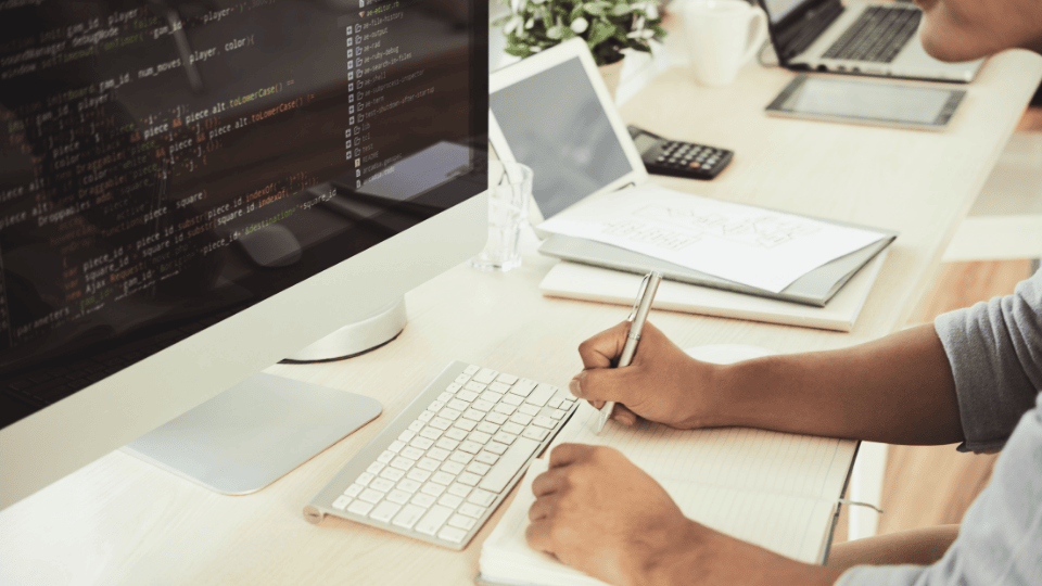 Developer coding on a computer for website development.