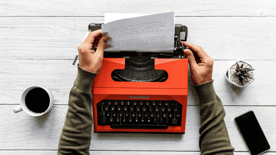 Content writing process, with a writer typing blog posts and articles for online platforms.