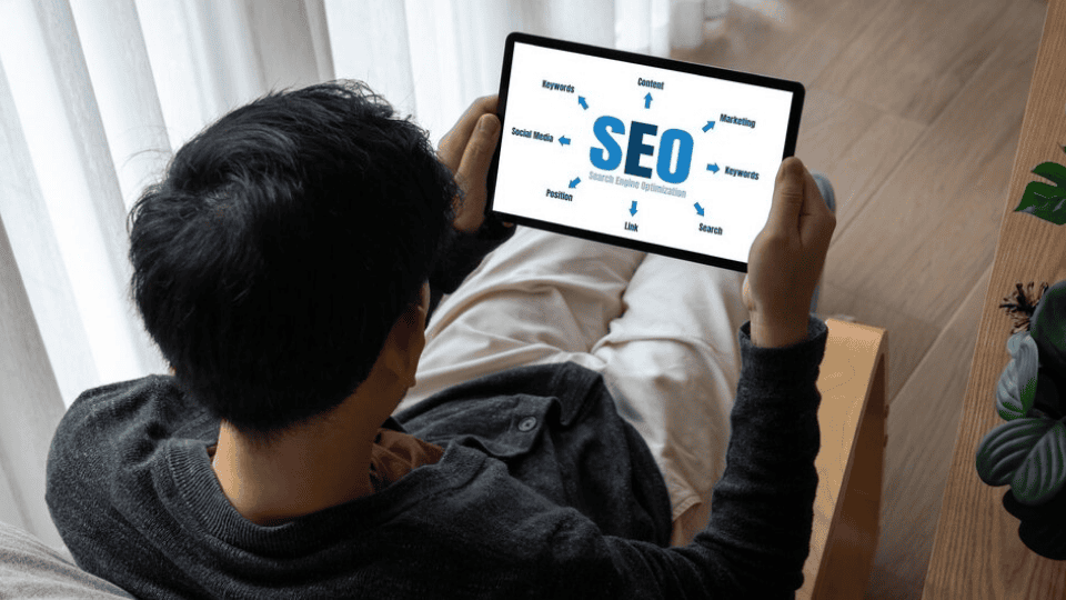 Person viewing an SEO diagram on a tablet, highlighting SEO Services.